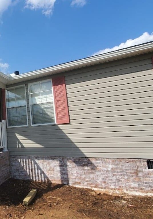 New Green siding on house with red shutters